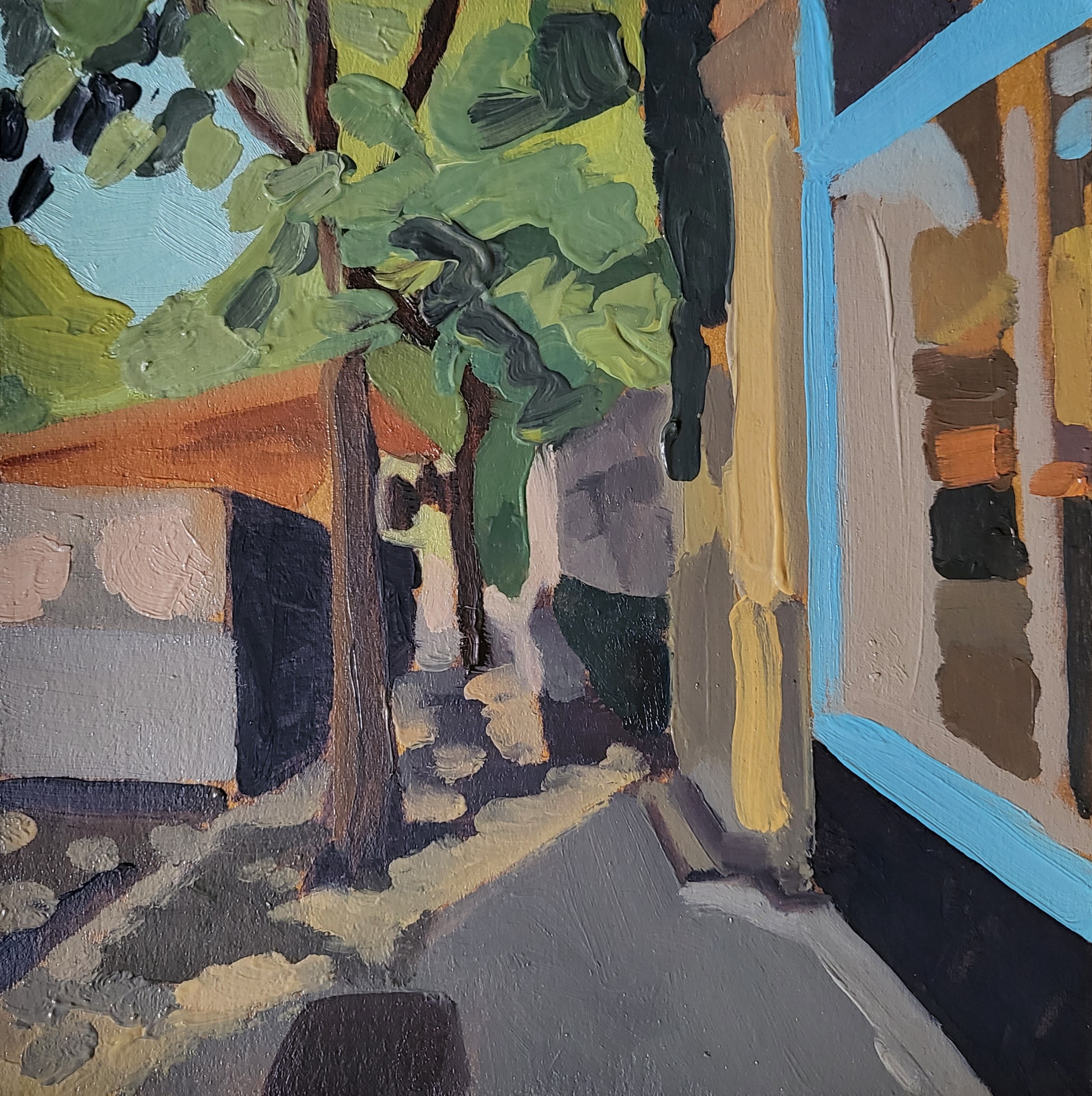 green tree and dappled light on sidewalk
