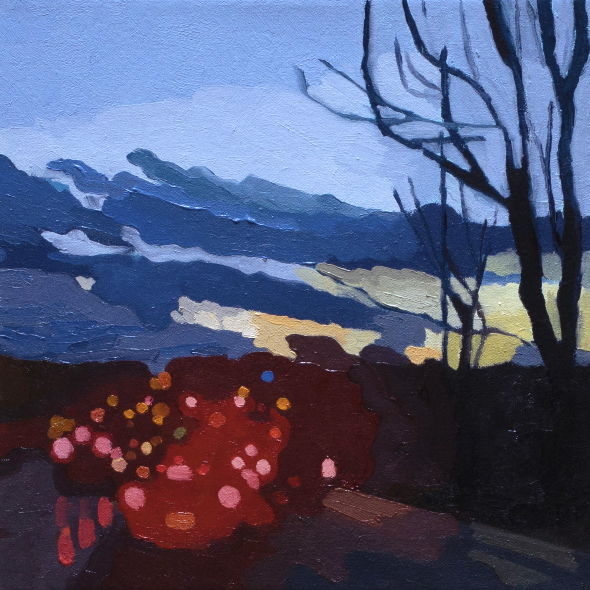 blurred red brake lights in traffic with a cool winter sunset sky